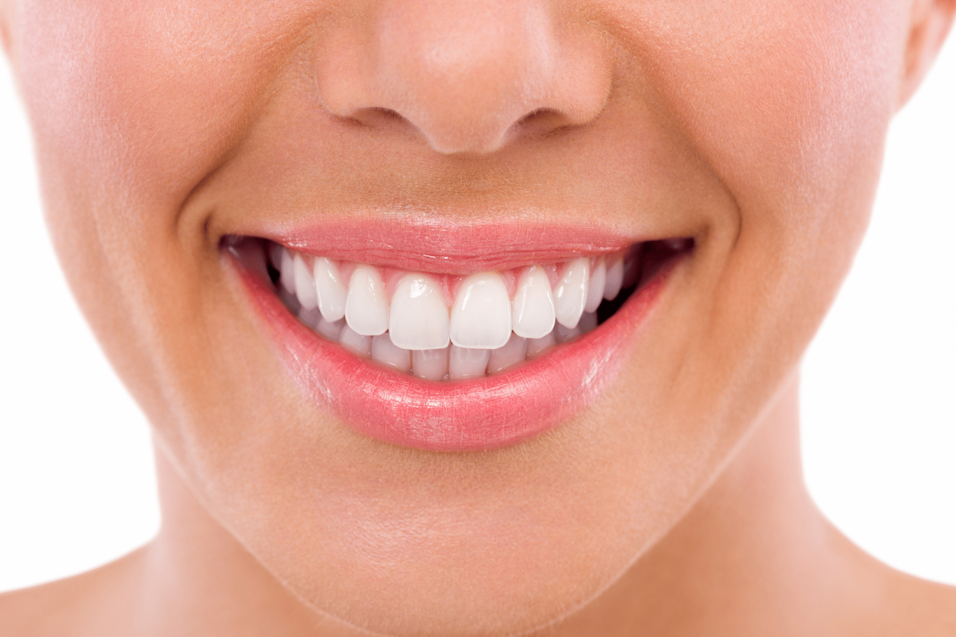 A close-up of a person smiling, showing perfect white teeth and healthy gums.